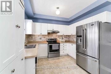 Brampton (Bram East) duplex for rent - A kitchen with a stove top oven and a refrigerator.