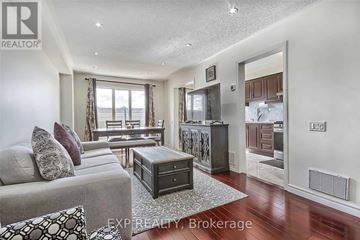 Toronto (West Humber-Clairville) townhouse for rent - A well-lit living room with a grey sofa and a coffee table.