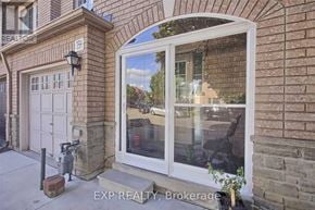Toronto (West Humber-Clairville) townhouse for rent - A real estate photo of a house with a white door and a window.