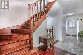 Toronto (West Humber-Clairville) townhouse for rent - A wooden staircase leads to a white door in a home.