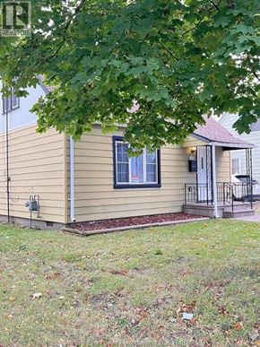 Windsor apartment for rent - A house with a small porch and a window.