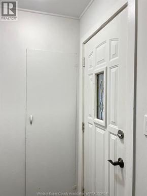 Windsor apartment for rent - A white door with a glass window and a black handle.