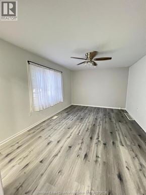 Windsor apartment for rent - A room with a ceiling fan and wooden flooring.