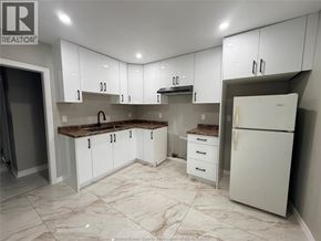 Windsor apartment for rent - A kitchen with white cabinets and a marble floor.