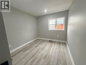 Windsor apartment for rent - A room with a window and wooden flooring.