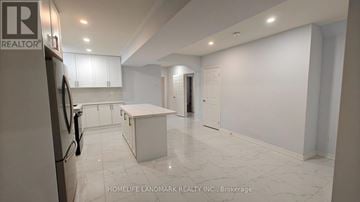 Vaughan (Vellore Village) apartment for rent - A kitchen with white cabinets and a marble floor.