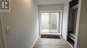 Vaughan (Vellore Village) apartment for rent - A room with a sliding glass door and a red mat on the floor.