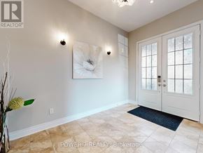 Aurora (Aurora Estates) apartment for rent - A room with a white door, a painting on the wall, and a vase with dried flowers on the floor.