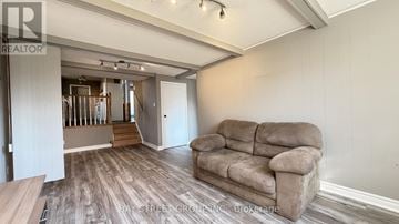 Markham (Royal Orchard) apartment for rent - A living room with a couch and a staircase in the background.