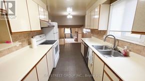 Markham (Royal Orchard) apartment for rent - A kitchen with white appliances and beige cabinets.