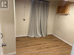 Barrie (Grove East) apartment for rent - A room with a curtain and a wooden board on the wall.
