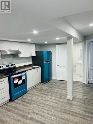 Milton (Ha Harrison) apartment for rent - A kitchen with a blue oven and white cabinets.
