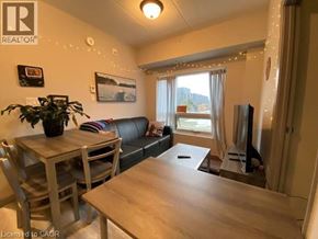 Waterloo condo for rent - A living room with a couch, a table, and a television.