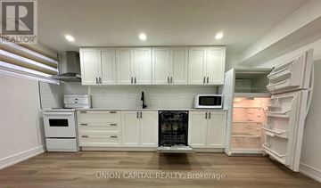 Toronto (Parkwoods-Donalda) apartment for rent - A kitchen with white cabinets and appliances is on the market with Union Capital Realty.