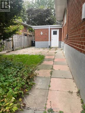 Toronto (Tam O'shanter-Sullivan) apartment for rent - A brick building with a white door and a small porch.