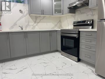 Toronto (Tam O'shanter-Sullivan) apartment for rent - A kitchen with grey cabinets and a marble floor.