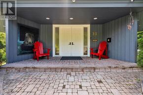 Oro-Medonte (Horseshoe Valley) apartment for rent - A house numbered 23 with two red chairs in front.