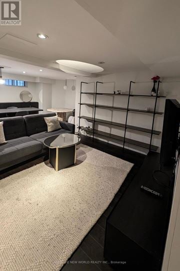 Toronto (South Parkdale) apartment for rent - A modern living room with a grey sofa and a round coffee table.