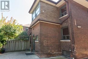 Toronto (South Parkdale) apartment for rent - A brick house with a sign that says "REALTOR" on it.