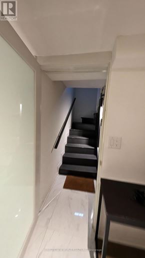 Toronto (South Parkdale) apartment for rent - A hallway with a staircase and a white wall.