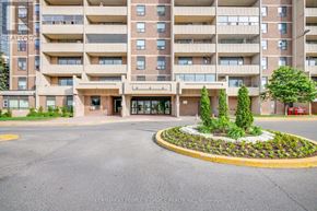 Toronto (Humbermede) condo for rent - A large apartment building with a landscaped courtyard in front.