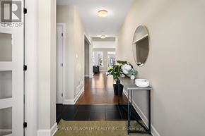 Russell apartment for rent - A hallway with a mirror and a plant on a console table.