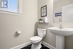 Russell apartment for rent - A white toilet sits next to a white sink in a bathroom.