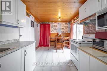 Niagara Falls (Arad/Fallsview) apartment for rent - A kitchen with white cabinets and a wooden ceiling.