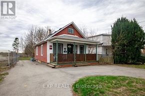 Niagara Falls (Arad/Fallsview) apartment for rent - A red house with a white roof and a sign that says EXP REALTY Brokerage.