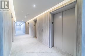 Vaughan (Vaughan Corporate Centre) condo for rent - A long hallway with a white floor and walls, and a row of white doors on the right side.