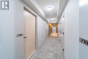 Vaughan (Vaughan Corporate Centre) condo for rent - A hallway with a tiled floor and doors on either side.