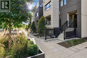 Burlington townhouse for rent - A sunny day at a modern apartment complex with a REALTOR® sign.