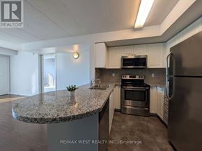 Brampton (Sandringham-Wellington) condo for rent - A white car is parked in front of a brick apartment building.