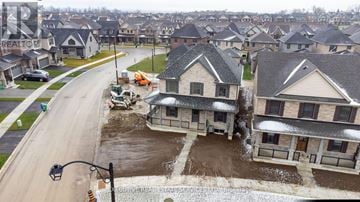Peterborough (Northcrest Ward 5) apartment for rent - A flooded street in a residential area with houses on either side.