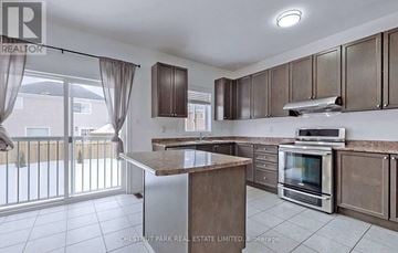 Shelburne apartment for rent - A kitchen with a stove top oven and a microwave.