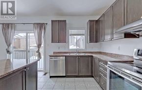 Shelburne apartment for rent - A kitchen with a refrigerator, oven, and cabinets.
