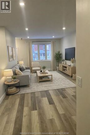 Windsor apartment for rent - A living room with a grey couch and a wooden coffee table.