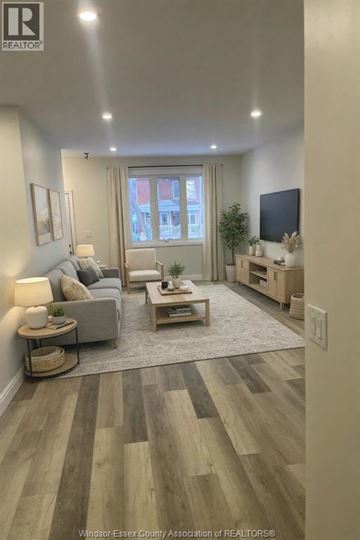Windsor apartment for rent - A living room with a grey couch and a wooden coffee table.