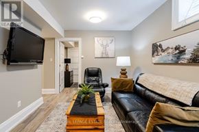 Toronto (Birchcliffe-Cliffside) apartment for rent - A living room with a black leather couch and a wooden coffee table.