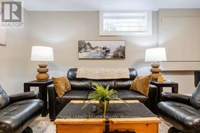 Toronto (Birchcliffe-Cliffside) apartment for rent - A living room with black leather couches and a wooden coffee table.
