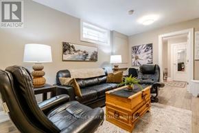 Toronto (Birchcliffe-Cliffside) apartment for rent - A living room with a black leather couch and a wooden coffee table.