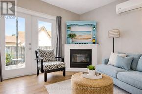 Casselman apartment for rent - A living room with a fireplace and a painting of a beach scene on the wall.