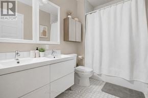 Casselman apartment for rent - A white bathroom with a toilet, sink, and shower curtain.