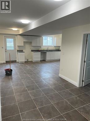 Windsor apartment for rent - A kitchen and living room with tile flooring and white walls.