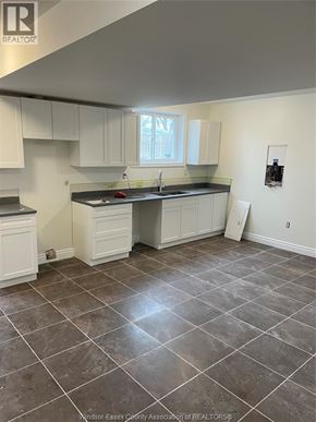 Windsor apartment for rent - A kitchen with white cabinets and a tile floor.