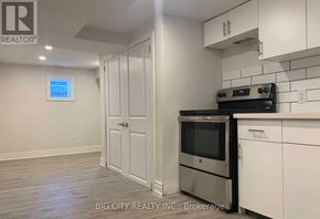 Toronto (Rockcliffe-Smythe) apartment for rent - A kitchen with white cabinets and a stainless steel oven.