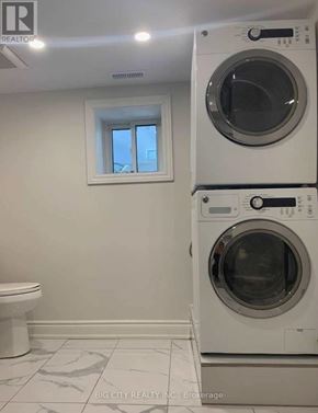 Toronto (Rockcliffe-Smythe) apartment for rent - A white washer and dryer in a laundry room.