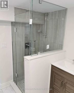 Toronto (Rockcliffe-Smythe) apartment for rent - A shower area with a glass door and a white counter.