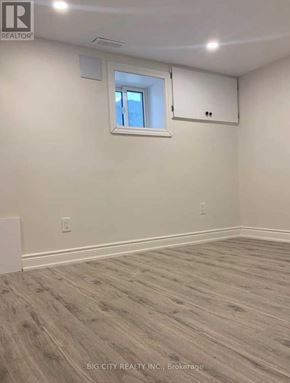 Toronto (Rockcliffe-Smythe) apartment for rent - A room with a window and wooden flooring.