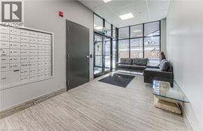 Cambridge apartment for rent - A waiting area with a couch, chair, and a board with names on it.